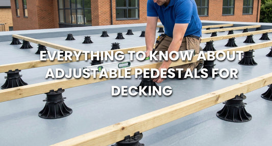 Professional installation of adjustable decking pedestals on a grey GRP fibreglass roof.