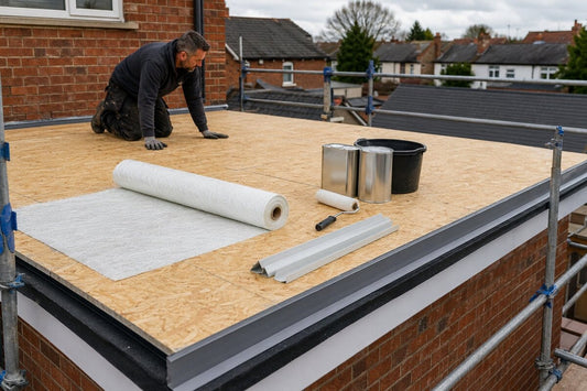 Roofer checking an OSB3 flat roof deck with GRP matting, resin and trims ready for installation.