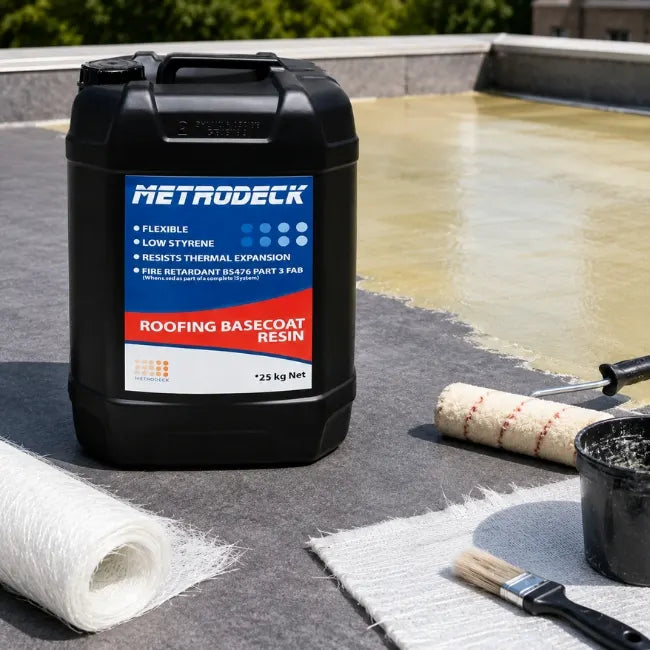 Metrodeck Roofing Basecoat Resin shown on flat roof with fibreglass matting, roller, brush and roofing tools